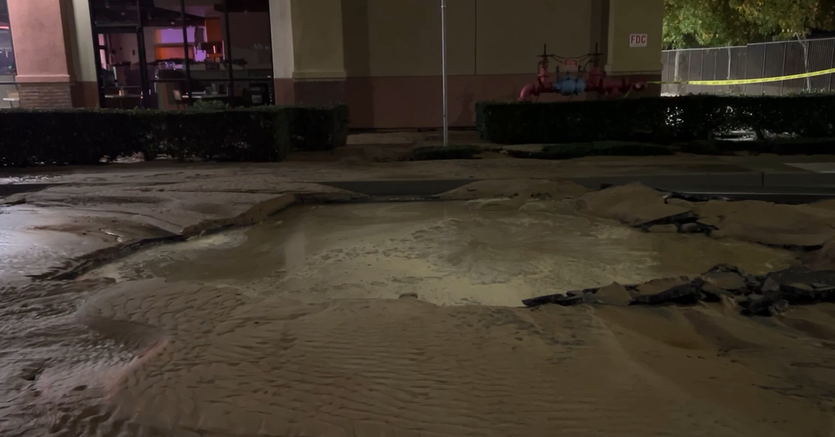 Water floods West McCoy Lane in Santa Maria, sinkhole causes at least one car accident